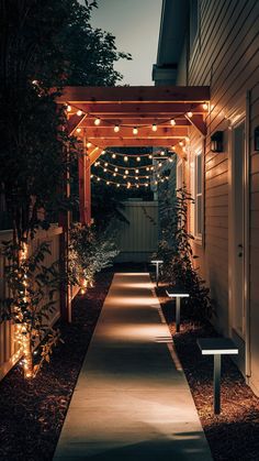 an outdoor walkway lit up with string lights