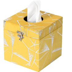 a tissue dispenser in a yellow box with white paint splattered on it