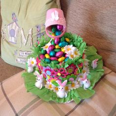 a cake decorated with easter eggs and flowers