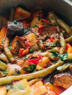 a pot filled with cooked vegetables on top of a stove