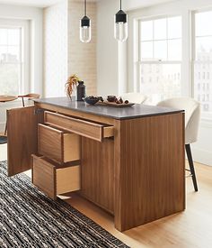 a kitchen with an island and wooden cabinets