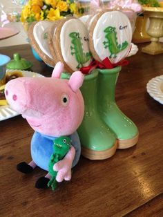 a peppa pig figurine sitting on top of a wooden table