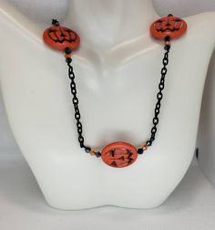 Ready to show off your Halloween spirit? This is the perfect piece to let the world know it's time to get spooky! This necklace features a combination of large orange Jack-O'-Lantern beads and small black and orange crystals with small lengths of black chain. This piece screams Halloween, but has just enough subtlety if you can't exactly scream at the office (but it will still loudly whisper Halloween). The best part? Not only is this necklace 100% Halloween, but Jack-O'-Lanterns can absolutely work throughout the fall season! Pairs perfectly with matching earrings found here: https://www.etsy.com/listing/838739122 Adjustable Necklaces For Halloween Costume Party, Halloween Themed Black Necklace, Black Themed Necklace For Halloween, Themed Black Necklace For Halloween, Handmade Jewelry For Halloween Costume Party, Spooky Orange Halloween Jewelry, Handmade Black Beaded Necklace For Halloween, Halloween Necklace With Round Beads, Halloween Adjustable Round Bead Necklaces