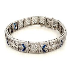 "Art Deco Diamond and Blue Sapphire Filigree 14k White Gold Bracelet  Antique Vintage  -  ET611 This is a stunning Art Deco bracelet. Crafted from 14k white gold with  21 open filigree links. The center 11 links of the bracelet are adorned with natural  Blue Sapphires and Genuine Round cut sparkling Diamonds. When the clasp is closed, it cannot be seen and there is an additional safety latch as well as a safety chain The detailing and filigree work in each link is beautiful. Bracelet is 6.75\" long and fits a small wrist size. This bracelet is made with 12 French cut  Blue Sapphire Baguettes (0.60 ctw) and 5 Round Brilliant Cut Diamonds (0.50 ctw, SI1- VS2 Clarity, and G Color.)  Sapphires = .60ctw Diamonds = .50ctw Total Weight of all Diamonds and Sapphires = 1.10ctw Solid 14kt White Gold Art Deco White Gold Bracelet For Formal Occasions, Formal Art Deco White Gold Bracelet, Art Deco Platinum Diamond Cut Bracelet, Art Deco Diamond Cut Platinum Bracelet, Luxury Blue Diamond Bracelet For Formal Occasions, Luxury Blue Diamond Bracelet For Formal Events, Classic Formal Bracelets With Intricate Design, Art Deco Hand Set Bracelets For Formal Occasions, Formal Art Deco Tennis Bracelet