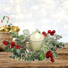 a candle is sitting on a table next to some christmas decorations