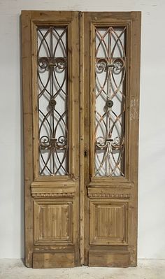 an old pair of wooden doors with glass panels