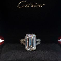 a fancy diamond ring sits on display in a box