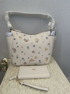 Coach Rori Shoulder Bag With Wild Meadow Print Gold/Chalk Multi & Wallet. (Set) New With Tags. Refined pebble leather Inside zip, cell phone and multifunction pockets Zip-top closure, fabric lining Adjustable handle with 11" drop Outside zip pocket 11 1/2" (L) x 9 1/2" (H) x 4 3/4" (W) Style No. C4091. Accordion Zip Wallet With Wristlet Strap Gold/Chalk Refined pebble leather 12 credit card slots Full-length bill compartments Zip coin pocket Zip-around closure Outside open pocket Detachable wris Zip Wallet, Free Items, Wrist Strap, Pebbled Leather, Bags Handbags, Zip Pockets, Chalk, Bag Lady, Shoe Accessories