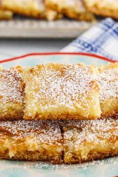 several pieces of cake sitting on top of a red and white plate next to each other