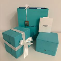 two blue boxes with white ribbons and a bow on the top, one is empty