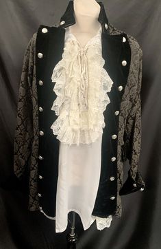 This is a stunning vintage jacket by Raven clothing. It is a olive / black colour, with a woven vintage design . It has black velvet cuffs and collar with metal ornate buttons down the front. It is an open fronted pirate style jacket so could fit upto a 42chest. The shirt is an off white, cream satin type of fabric with frill front and cuff. Please refer to photo. This is an oversized baggy style shirt by sacrifice a label of raven clothing. Please check photos for measurements  Thank you Piratecore Fashion, Gothic Pirate, Pirate Style, Victorian Men, Pirate Fashion, Black Top Hat, Vintage Steampunk, Baggy Style, Clothes Diy