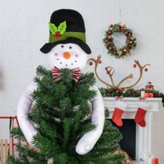 a snowman sitting on top of a christmas tree