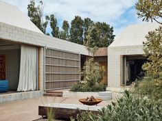 an outdoor area with concrete walls and plants