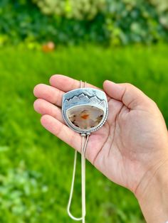 Montana Agate bolo chain necklace. I’ve been holding onto this stone since April of 2023 because I knew it was destined for a special project like this one. The stone was ethically sourced and cut by a fellow female-owned small business. The Montana agate has a sunset scene in it, with the orange being the setting sun and the lines looking like mountains to me. I designed this so it looks like the setting sun below the mountain, which I carved out of the silver. This piece was made with an extre Handmade Sterling Silver Bolo Tie As Gift, Artisan Lariat Necklace With Natural Stones For Gift, Adjustable Oval Agate Jewelry, Agate Jewelry With Adjustable Chain, Handmade Agate Lariat Jewelry, Adjustable Agate Jewelry With Chain, Artisan Lariat Necklace Gift, Unique Lariat Necklace With Natural Stones For Gifts, Artisan Necklace With Large Adjustable Stone