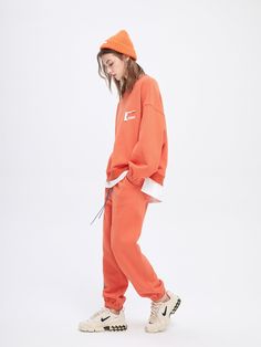 Details: Classic fleece sweatpants in tangerine Elastic waistband and cuffs Contrasting double drawstring Custom Urlazh embroidery on left leg Pair with Tangerine Cropped Sweatshirt Materials & Care: 53% Polyester, 47% Cotton Hand wash | Dry clean Do not bleach Size & Fit: Model is 5'7", Bust 32, Waist 24, Hips 35, wearing a size S Item #: JK4PA014H Cloud Sweatshirt, Hooded Wool Coat, Quilted Sleeves, Quilted Puffer Jacket, Fleece Sweatpants, Cotton Fleece, Crop Sweatshirt, Wool Coat, Denim Jeans