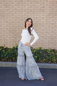 Embrace your playful side with our Palazzo Pants in Baby Blue Floral! These flowy pants feature a ditsy print and are oh-so-soft. Perfect for adding a touch of whimsy to any outfit! Paired with THE CROSS SANDALS IN TAN Tiered wide leg pants Decorative waist tie Elastic waistband Lined 100% polyester Runs true to size. Small (0-4), Medium (4-8), Large (8-12), X-Large (12-14). In-seams: Small: 31.5", Medium: 32", Large: 32.5", X-Large: 33" Model is 5'5" wearing a small. To view our return policy, Happy Threads, Summer Goddess, Ditsy Print, Swimming Outfit, Flowy Pants, Swim Bottoms, Palazzo Pants, British Indian, The Cross