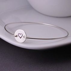 Lovely Hand Stamped Heart Jewelry For Friendship, Minimalist Bangle Jewelry For Valentine's Day, Minimalist Stainless Steel Heart Bracelet As Gift, Personalized Round Name Bracelet For Anniversary, Adjustable Stainless Steel Heart Bracelet For Anniversary, Anniversary Name Bracelet With Engraving Option, Minimalist Heart Charm Bracelets For Anniversary, Silver Personalized Heart Bracelet, Valentine's Day Adjustable Hand Stamped Bracelets