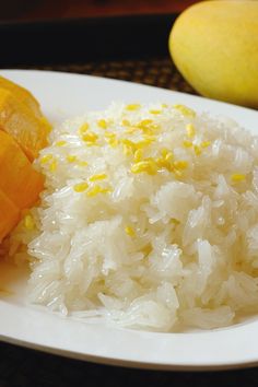 a plate with rice and mangoes on it