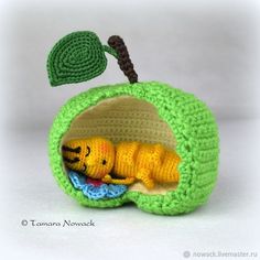 a crocheted stuffed animal in an apple