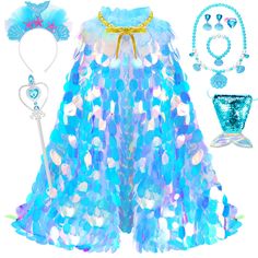 the costume is blue and white with sequins, pearls, necklaces, and other accessories