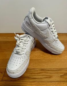 Personalized Pearl studded bridal Air Force 1 Sneakers Other types of sneakers can be customized - please message me! Personalization Section: Name Wedding Date Customization Requested Seller will send a proof within 72 hours of the lettering/date and work will begin 48 hours later if seller does not hear back. Options: 2 Outer Swoosh  - Both outer swooshes and back strip included All 4 Swoosh  - All 4 swooshes and back strip included All 4 Swoosh + U - Both outer swooshes, front U, and back strip included Name and Date can be included for $5 each MAKE SURE YOUR SIZE IS ACCURATE TO AIR FORCE 1 - NO RETURNS Please message me for an customization! All items are handmade for your order! Customized White Lace-up Sneakers, White Customized Lace-up Sneakers, Customizable White Sneakers With Round Toe, Customizable White Round Toe Sneakers, Custom White Lace-up Sneakers, Custom White Wedding Sneakers, Customizable White Custom Sneakers, Customizable White Wedding Sneakers, White Rhinestones Custom Sneakers For Streetwear