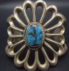 "VINTAGE NAVAJO BRACELET DESCRIPTION: This outstanding cuff features a gorgeous specimen of natural old Arizona blue turquoise. The gemstone is secure in smooth bezel, on a foundation of heavy gauge vintage sterling silver. This bracelet will be a cherished addition to your collection of fine vintage Native American jewelry. MEASUREMENTS: Interior of the cuff measures 4 7/8\" with an additional 1 5/8\" non-adjustable gap. Total circumference: 6 1/2\" Measures 2 3/8\" straight across the widest p Blue Oval Vintage Cuff Bracelet, Collectible Vintage Turquoise Ring With Polished Finish, Vintage Turquoise Ring With Polished Finish, Vintage Gemstone Cuff Bracelet Collectible, Vintage Oval Cuff Bracelet With Polished Finish, Vintage Sterling Silver Cuff Bracelet With Patina, Bones Bracelet, Vintage Native American Jewelry, Navajo Bracelet