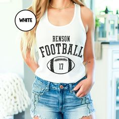 a woman wearing shorts and a tank top with the words benson football on it