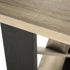 a close up view of a wooden table with black metal legs and an oak top