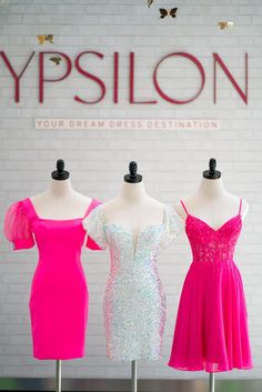 A mannequin in a fun cocktail dress features puffy semi-sheer cap sleeves with a square neckline and fitted silhouette. Prom Evening Dress With Short Sleeve And Fitted Bodice, Prom Season Dress With Fitted Bodice And Short Sleeves, Short Sleeve Prom Dress With Fitted Bodice, Short Sleeve Dress With Fitted Bodice For Prom, Short Sleeve Dresses With Fitted Bodice For Prom Season, Short Sleeve Dress For Prom Night Out, Summer Homecoming Dresses With Straight Neckline, Short Sleeve Dress For Night Out During Prom Season, Glamorous Square Neck Dresses For Prom