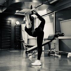 a woman is doing exercises in the gym