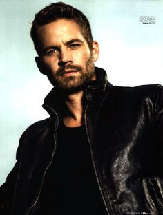 a man with a goatee wearing a leather jacket