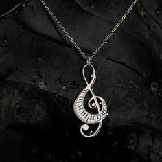 Elevate your ensemble with the timeless elegance of the Sussex Home Treble Clef Necklace. This exquisite piece is meticulously handcrafted from sterling silver and adorned with a lustrous gold plating, making it a stunning choice for any music enthusiast.

- Material: Sterling Silver, Gold Plated
- Color: Gold
- Gender: Female
- Age Group: Adult

Designed with a delicate treble clef pendant, this necklace serves as a symbol of your everlasting love for music. It's the perfect gift for bridesmaid Silver Music-themed Metal Jewelry, Music-themed Silver Metal Jewelry, Music-themed Metal Jewelry For Gifts, Silver Music-themed Metal Necklace, Silver Music-themed Round Jewelry, Nickel-free Silver Music-themed Necklaces, Nickel-free Metal Music-themed Jewelry, Nickel-free Music-themed Metal Jewelry, Music-themed Silver Pendant Necklace