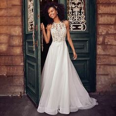 a woman standing in front of a green door