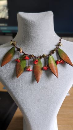 Adorn yourself with a touch of nature's elegance with our Handmade Bohemian Leather Necklace. Crafted with intricate leaf design, this necklace exudes a mesmerizing charm that is sure to captivate attention. Featuring genuine Coral stones, each carefully handpicked and arranged to add a splash of vibrant color and natural beauty to your ensemble. Individually handcrafted with love and attention to detail, this necklace is a true testament to the skill and artistry of our artisans. Each piece is not just handmade but also handpainted, ensuring that you own a truly one-of-a-kind accessory that reflects your unique sense of style. Embrace the extraordinary with this special design that sets you apart from the crowd. Elevate your fashion statement with our Handmade Bohemian Leather Necklace to Adjustable Red Nature-inspired Jewelry, Handmade Red Nature-inspired Necklace, Unique Leaf-shaped Jewelry For Jewelry Making, Handmade Leaf-shaped Nature-inspired Jewelry, Elegant Handmade Leaf Necklace, Handmade Elegant Leaf-shaped Necklace, Unique Handmade Leaf-shaped Jewelry, Unique Leaf-shaped Necklace For Gifts, Brown Leaf-shaped Jewelry For Gift