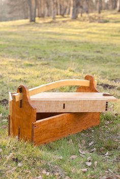 a wooden bench sitting on top of a lush green field