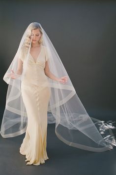 a woman in a wedding dress with a veil on her head