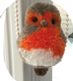 an orange and gray stuffed animal hanging from a hook