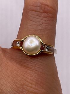 Vintage white cultured pearl  Sterling silver with gold setting   Re sizing has a $20 jeweler's fee. All rings are shipped in a nice gift box.   Check out our over a THOUSAND great reviews Engraving is $4 per letter and is not always perfect depending on the piece. It can take a few days if the jeweler is busy. This is payable to Paypal Judithsltd@gmail.com Gold Pearl Ring Stamped 14k For Gift, Vintage Gold Jewelry Aaa Quality, White Round Cut Pearl Ring For Anniversary, White Heirloom Jewelry With High Luster, Heirloom White Jewelry With High Luster, White High Luster Heirloom Jewelry, Vintage High Quality Jewelry For Formal Occasions, Hallmarked Oval Pearl Ring For Anniversary, Oval Hallmarked Pearl Ring For Anniversary