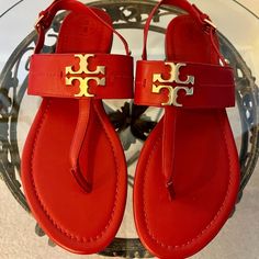 New! Never Worn!! A Classy And Comfortable Style, These Red Leather Bryce Flat Sandals From Tory Burch Go With Any Outfit. A Gleaming Gold Hardware Tory Burch T Logo Medallion Takes Center Stage On A Beautifully Smooth Thong Sandal Fitted With An Adjustable Buckle Slim Slingback Strap, A Padded Footbed, A Leather Outsole And A Stacked Low Heel. Color: Red With Gold Hardware Material: Leather Upper; Rubber Sole Size: 7m Red Open Toe T-strap Sandals, Red T-strap Sandals With Ankle Strap, Red Ankle Strap T-strap Sandals, Red Flat Slingback Sandals For Spring, Red T-strap Sandals For Beach, Red Sandals With Branded Insole And Single Toe Strap, Red Sandals With Single Toe Strap, Red T-strap Sandals For Spring, Tan T-strap Sandals For Spring