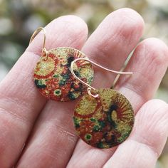 Groovy Bloom coin earrings with an etched and printed design of colorful blooms on a gold finish charm. They are lightweight and colorful with a textured surface with a subtle shimmer. Gold plated earwires. Earrings measure 1 1/4" from the top of the earwire. Find more great earrings here http://www.etsy.com/shop/everybeadofmyart?section_id=8084100 Thanks for shopping Every Bead of My Art! Multicolor Brass Earrings For Festivals, Hand Painted Gold Earrings For Festival, Gold Hand Painted Earrings For Festivals, Artsy Gold Earrings Made Of Copper, Artsy Gold Copper Earrings, Bohemian Hand Painted Brass Earrings, Hand Painted Copper Bohemian Earrings, Bohemian Hand Painted Copper Earrings, Gold Earrings With Artistic Design For Festivals