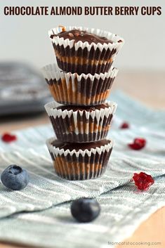 three chocolate almond butter berry cups stacked on top of each other