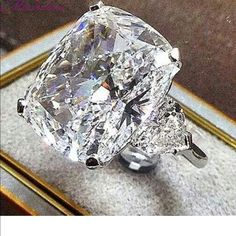 a large diamond ring sitting on top of a table