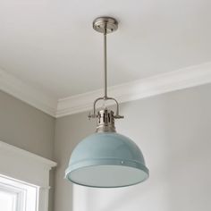 a blue light hanging from the ceiling in a room with gray walls and white trim