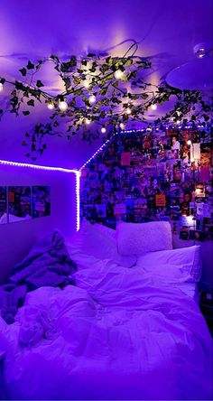 a bedroom with purple lighting and lots of pictures on the wall