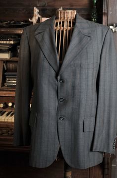 "This is a Grey and Blue Mod Fitted Swinging 60's light wool suit. Tailored by Bennett of New Haven for The Racquet Shop of Mississippi. The tailoring is excellent as is the quality of the fabric. It is a Shadow Strip with a Grey base and various shades of Black and Red used in the Stripes. There is a great Jacket details. The Pants are matching Flat Front with a 60's style Stovepipe cut. It is a men's size 40 or Medium with pants sized 34 / 33 The end of the leg is unfinished right now) ... but Retro Tailored Wool Suits, Vintage Semi-formal Suits With Button Closure, Vintage Three-piece Suit With Notch Lapel For Business, Retro Tailored Single Breasted Suits, Retro Single-breasted Suits For Tailoring, Vintage Tailored Three-piece Suit For Formal Occasions, Vintage Tailored Suit For Formal Occasions, Tailored Vintage Three-piece Suit, Vintage Three-piece Suit With Suit Collar For Business