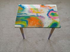 a small table with colorful paint on it