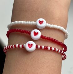 A lovely combination of translucent red, white & pink beads perfectly finished with a gorgeous red heart threaded on a stretchy elastic for easy access. It will look great stacked or worn by itself. These are fab gifts for baby showers, bridal favours, friendship groups, couples, mothers, keepsakes, etc All my designs are lovingly handmade. Please message me if you require a different size or want to put in a special order. Bracelets not suitable for children under 3years old as it contains small parts that can be swallowed. Care instructions  Please keep bracelets away from contact with water, chemicals or perfumes.  Thanks for visiting and happy shopping ☺️ Cheap Adjustable Friendship Bracelets With Heart Beads, Trendy Red Jewelry With Heart Beads, White Heart Beads Jewelry For Valentine's Day, Valentine's Day White Heart Beads Jewelry, Cute Stretch Bracelet With Round Beads For Valentine's Day, White Friendship Bracelets For Valentine's Day, Cute Red Bracelets For Valentine's Day, Cute Red Beaded Bracelets With Heart Beads, Cute Red Beaded Bracelet With Heart Beads