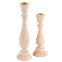 two wooden candlesticks are standing next to each other on a white background,