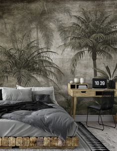 a bedroom with palm trees on the wall and a bed in front of a desk