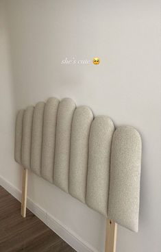 a row of chairs sitting on top of a wooden floor next to a white wall